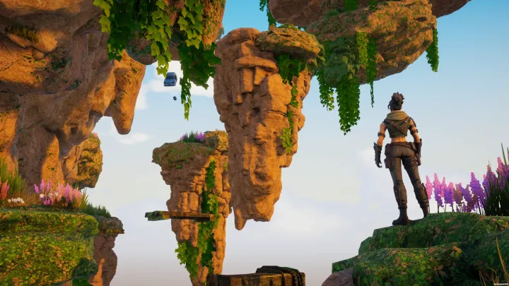 Players scaling a canyon wall at dusk
